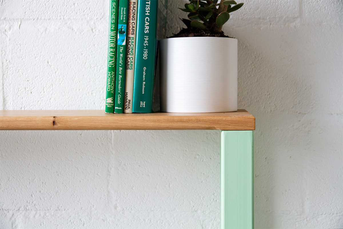 bench being used as a shelf to display books and a house plant