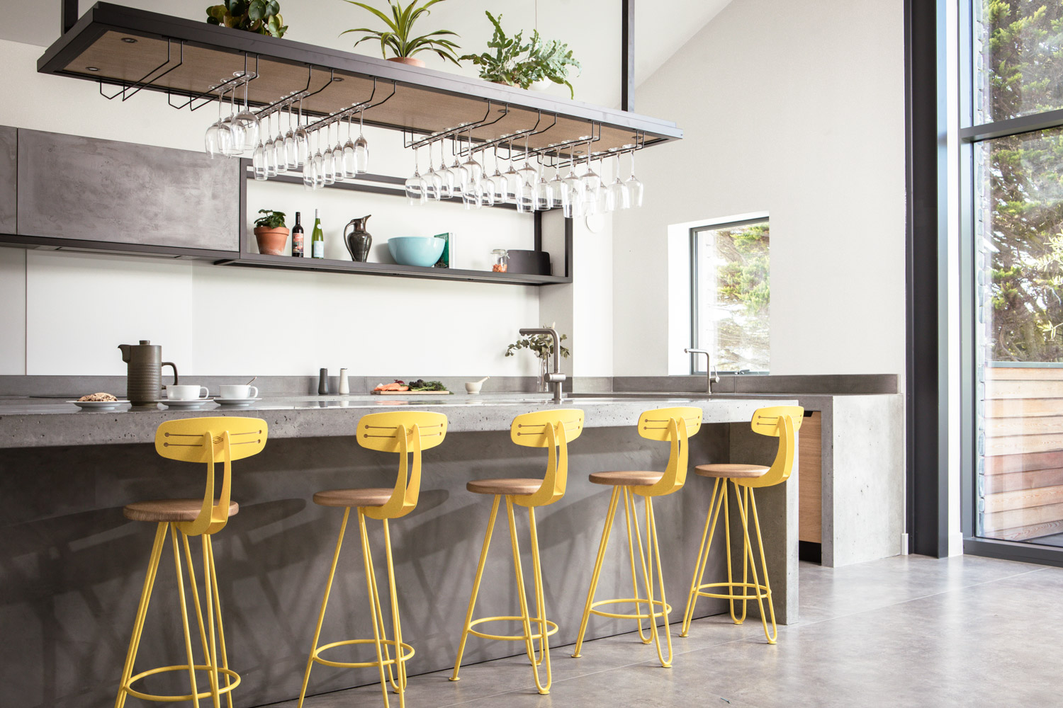 One of our interiors. A kitchen island with yellow hairpin leg bar stools