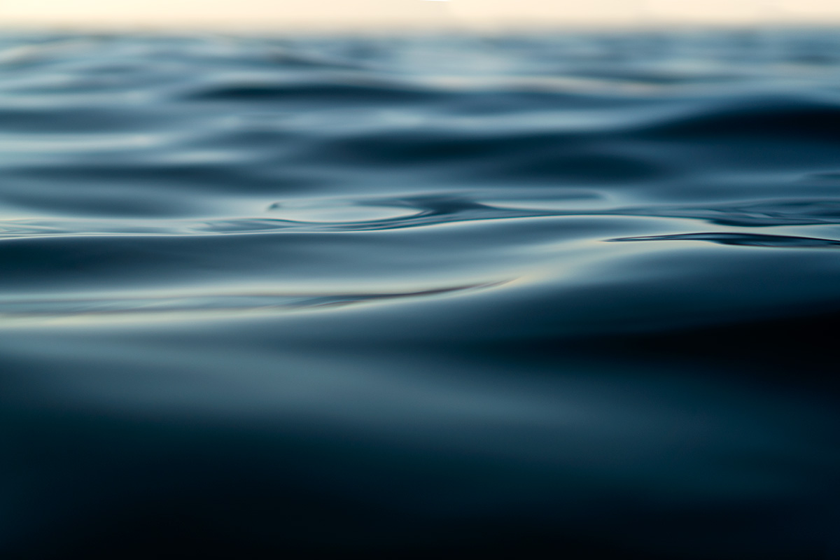 close-up photograph of the surface of the sea at sunset by Mat Arney